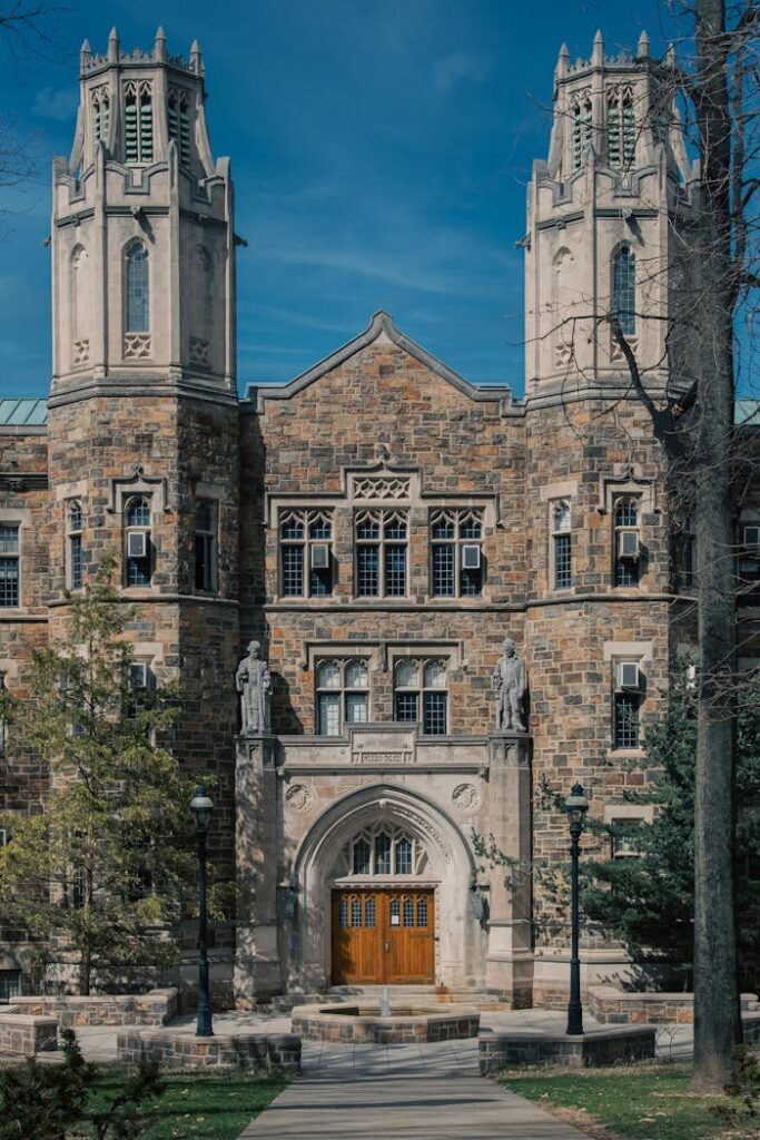 Mastering the First Impression: Your intriguing post title goes here Majestic Gothic Revival building at a university campus with towers and detailed facade.